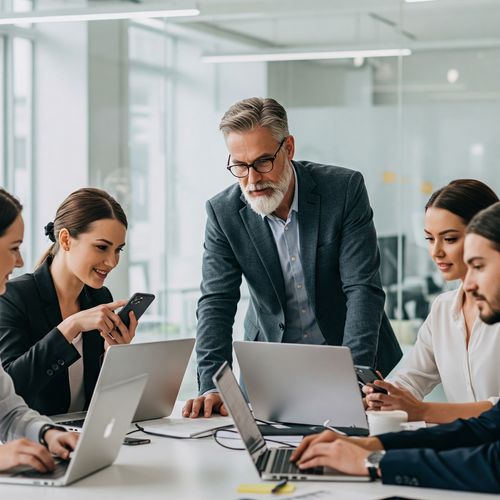 O echipă diversă și entuziastă lucrează colaborativ într-un birou modern, utilizând laptopuri și smartphone-uri, simbolizând succesul și dinamismul unei afaceri MLM prospere.